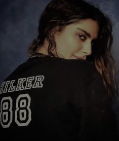 a woman with long hair wearing a black shirt