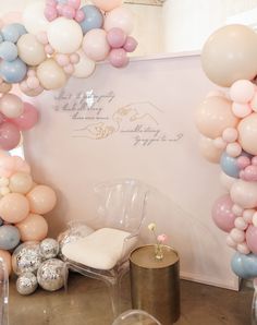 balloons and chairs are set up in front of a wall