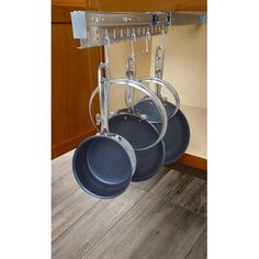 pots and pans are hanging from the rack