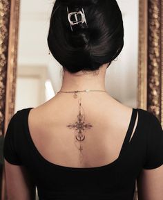 a woman with a cross tattoo on her back