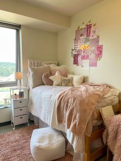 a bedroom with pink and white decor on the walls, carpeted floor and bed