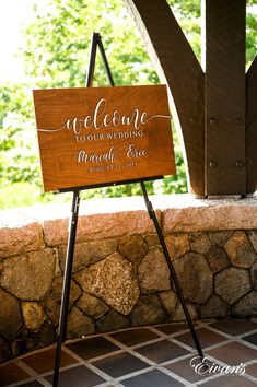 a wooden sign that says welcome to your wedding