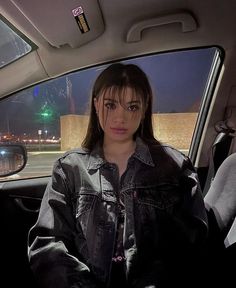 a woman sitting in the passenger seat of a car