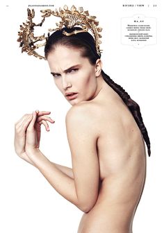 a naked woman with braids and a crown on her head is posing for the camera