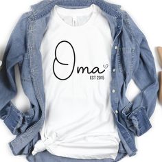 Introducing our Custom Oma shirt, the perfect gift for that special Oma in your life! Made with love and care, this Oma Crewneck is not only stylish but also meaningful. Whether you're looking for a holiday gift for Oma, a Mothers Day surprise, or a pregnancy reveal, this Oma T Shirt is sure to bring a smile to her face. Show your appreciation and gratitude by gifting her this personalized Oma TShirt. With its comfortable fit and trendy design, it's perfect for everyday wear or special occasions Personalized White Shirt As Gift, Personalized White Shirt For Gift, Family Long Sleeve T-shirt For Mother's Day, Long Sleeve T-shirt For Mother's Day Family Event, Long Sleeve T-shirt For Mother's Day, Mother's Day Cotton T-shirt, Mother's Day Anniversary Cotton T-shirt, Long Sleeve T-shirt For Mother's Day Gift, Casual Cotton Shirt For Anniversary