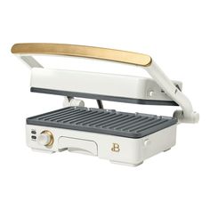 an electric waffle maker with a gold handle on it's top and bottom