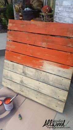 the pallet is being painted orange and white