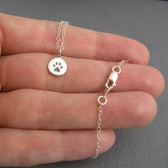 "tiny silver paw print necklace. small sterling silver pet pride pendant. pet charm. gift animal lover simple pawprint dog cat simple jewelry Perfect little way to show how much you ❤ your pet! - Tiny sterling silver paw print circle charm, slightly under 3/8\" (9 mm) across. - Necklace length 17\" (43 cm), 1.5 mm cable chain, lobster clasp, and locking circle jump rings, all sterling silver. - Paw print is a cast imprint, so the design is always perfectly aligned. Imprint is oxidized (blackened Sterling Silver Paw Print Jewelry For Gifts, Sterling Silver Paw Print Necklace For Gift, Silver Paw Print Round Pendant Necklace, Sterling Silver Paw Print Jewelry Gift, Sterling Silver Paw Print Necklace As Gift, Minimalist Sterling Silver Charm Necklace For Best Friend, Sterling Silver Jewelry With Paw Print, Dainty Sterling Silver Charm Necklace For Best Friend, Hypoallergenic Sterling Silver Jewelry For Best Friend