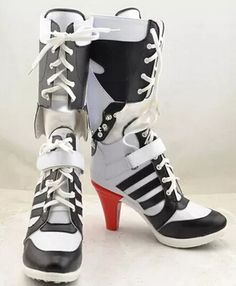 a pair of black and white high heel boots with red soles on the bottom