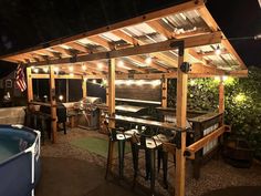 an outdoor bar with lights on the roof