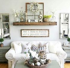 a living room filled with white furniture and lots of flowers on top of the coffee table