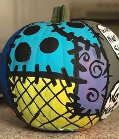 a painted pumpkin sitting on top of a counter