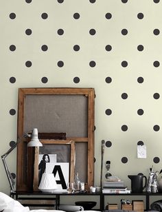 a living room with black and white polka dot wallpaper