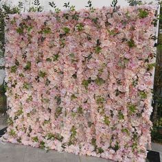 a large pink flowered wall in front of a building