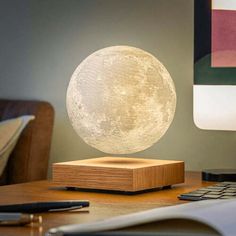 a desk with a lamp on top of it and a keyboard in front of it