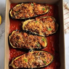 baked eggplant stuffed with cheese and sauce in a baking dish on a marble countertop