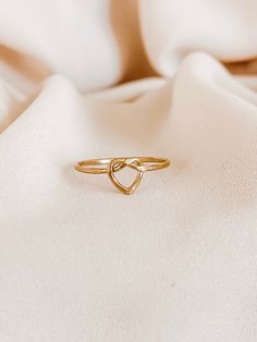 Heart Knot Ring, Love Knot Ring, Gold Infinity Heart Ring, Heart Knot Ring Gold, Gold Stacking Rings, Gold Knot Ring, Silver Knot Ring   This Ring is so lovely and gorgeous. Created from gold-filled, rose gold-filled, or sterling silver round wire, this ring features an open heart-shaped with a love-knot design and presents an attractive, dainty look. *CURRENT PRODUCTION WORKS* All items are made to order. Please check our policies page, our time to work 8-10 business days, or for the updated pr Elegant Adjustable Heart-shaped Stackable Rings, Adjustable Heart Ring For Valentine's Wedding, Adjustable Open Heart Promise Jewelry, Adjustable Heart Ring For Wedding On Valentine's Day, Minimalist Adjustable Heart Ring For Wedding, Adjustable Double Heart Rings For Wedding, Adjustable Double Heart Wedding Rings, Gold Stackable Rings With Heart Charm For Wedding, Adjustable Minimalist Heart Ring For Promise