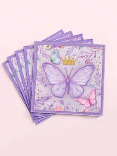 four purple cards with butterflies on them