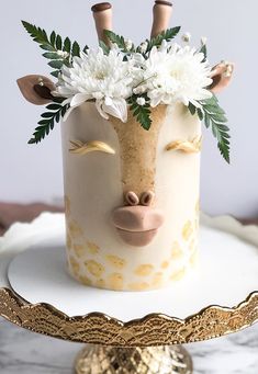 a cake decorated with flowers and giraffe's head