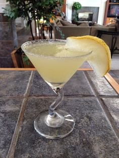 a glass filled with a drink sitting on top of a table