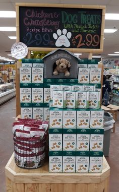 dog treats are on display for sale in a pet store with a sign above it