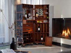 a living room with a fire place and wine glasses