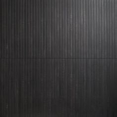 a black wall with vertical lines on it