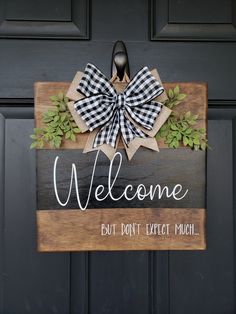 a welcome sign hanging on the front door