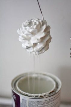 a paint can being filled with white whipped cream