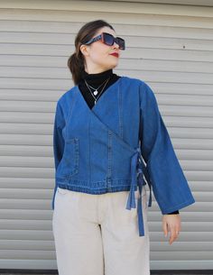 "The Ruby Wrap Around is a stylish collarless denim jacket. This wrap around jacket has two side fastenings to create a kimono style finish.  When to wear? This lose fit tie jean jacket is the perfect extra layer, Swap that cardigan and don your Ruby Wrap Around.  Jacket sizing and details: one size, models are sizes 12-14(uk) can fit between 10-16 (uk) Chest/Bust 46\" 117cm - Back length 21\" 53.5cm - Sleeve 22\" 56cm. Tie fastenings   *Every item at Reclaimed Roundabout is completely unique and one off due to the supply of preloved denim. About us: The Reclaimed Roundabout is run by a mother and daughter team who design and make everything in Brighton, England.  We are dedicated to handmade sustainable fashion with a touch of uniqueness.  Packaging: As a zero waste company we care for th Sunburnt Face, Collarless Denim Jacket, Brighton England, Wrap Jacket, Kimono Style, Style Expert, Summer Hats, Kimono Fashion, Wrap Around