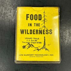 a yellow box with black writing on it that reads food in the wilderness upward tails