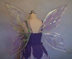 a purple and silver fairy costume on a mannequin