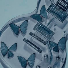 an electric guitar with blue butterflies on it