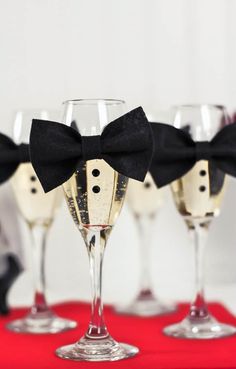 four wine glasses with black bow ties on them and the words diy mini bow ties party decor