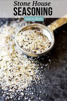 a spoon full of seasoning sitting on top of a black table with the words stone house