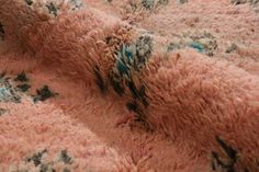 a close up view of a pink and black carpet with small flowers on the side