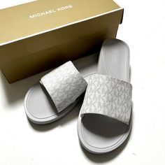 Stylish Michael Kors Signature Slide Sandals. From Michael Michael Kors, The Mk Logo Slides Feature: Synthetic Logo Upper Adjustable Hook And Loop Closure Unlined Rubber Outsole New With Box. Impeccable Condition. Size: 10 Color: White Item Comes From A Smoke Free Home. Michael Kors White Leather Sandals, Michael Kors White Sandals For Spring, White Michael Kors Sandals For Spring, Michael Kors Casual Synthetic Sandals, Michael Kors Synthetic Sandals With Branded Insole, Mk Logo, Michael Kors Shoes, Hook And Loop, Slide Sandals