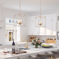 a kitchen with white cabinets and counter tops, gold chandelier hanging from the ceiling