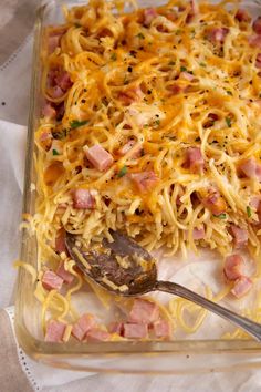 a casserole dish with ham, cheese and noodles