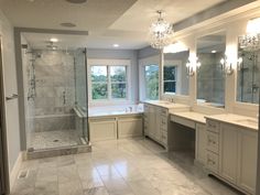 a large bathroom with two sinks and a walk in shower