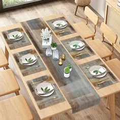 a dining room table set with place settings