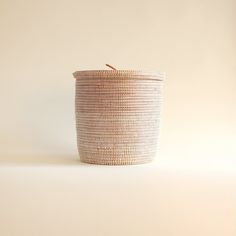 a white basket sitting on top of a table