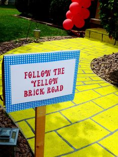 a yellow brick road with a sign that says follow the yellow brick road