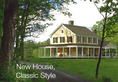 a large yellow house sitting in the middle of a lush green field next to a forest