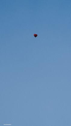 an airplane flying high in the sky on a clear day with no one around it