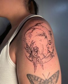 a woman's arm with a butterfly and a half moon tattoo design on it