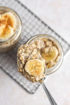 two small jars filled with oatmeal and banana slices on a cooling rack