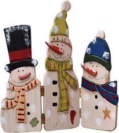 three snowmen wearing hats and scarves are standing next to each other