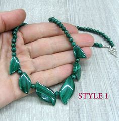 "Genuine Malachite gemstone beaded necklace, made of dark green stone beads in round and leaf shapes. Natural malachite jewelry, dainty bib necklace. Length: from 18 and 19 \" ( 46 and 48 cm ) - can be shortened on request. Beads: 4 mm balls and leaves measuring from 15 to 30 mm long. Please see all photos and select the style: Style 1 - the necklace with wider spread leaves, 19 inches long. Style 2 - the necklace with darker leaves placed closer together and making more V-shape, 18 inches long. Malachite Gemstone Bead Necklaces, Malachite Gemstone Beads Necklace, Green Oval Polished Beads Jewelry, Polished Malachite Round Beaded Necklaces, Green Oval Beads Necklaces For Gifts, Round Malachite Beaded Necklace, Green Oval Beaded Necklaces For Gifts, Dark Green Beaded Jewelry With Round Beads, Green Oval Gemstone Beads Jewelry