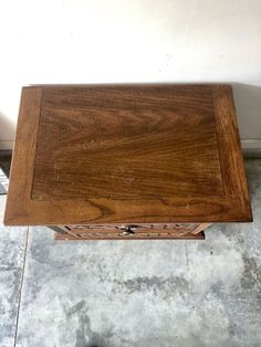 a wooden table sitting on top of a cement floor